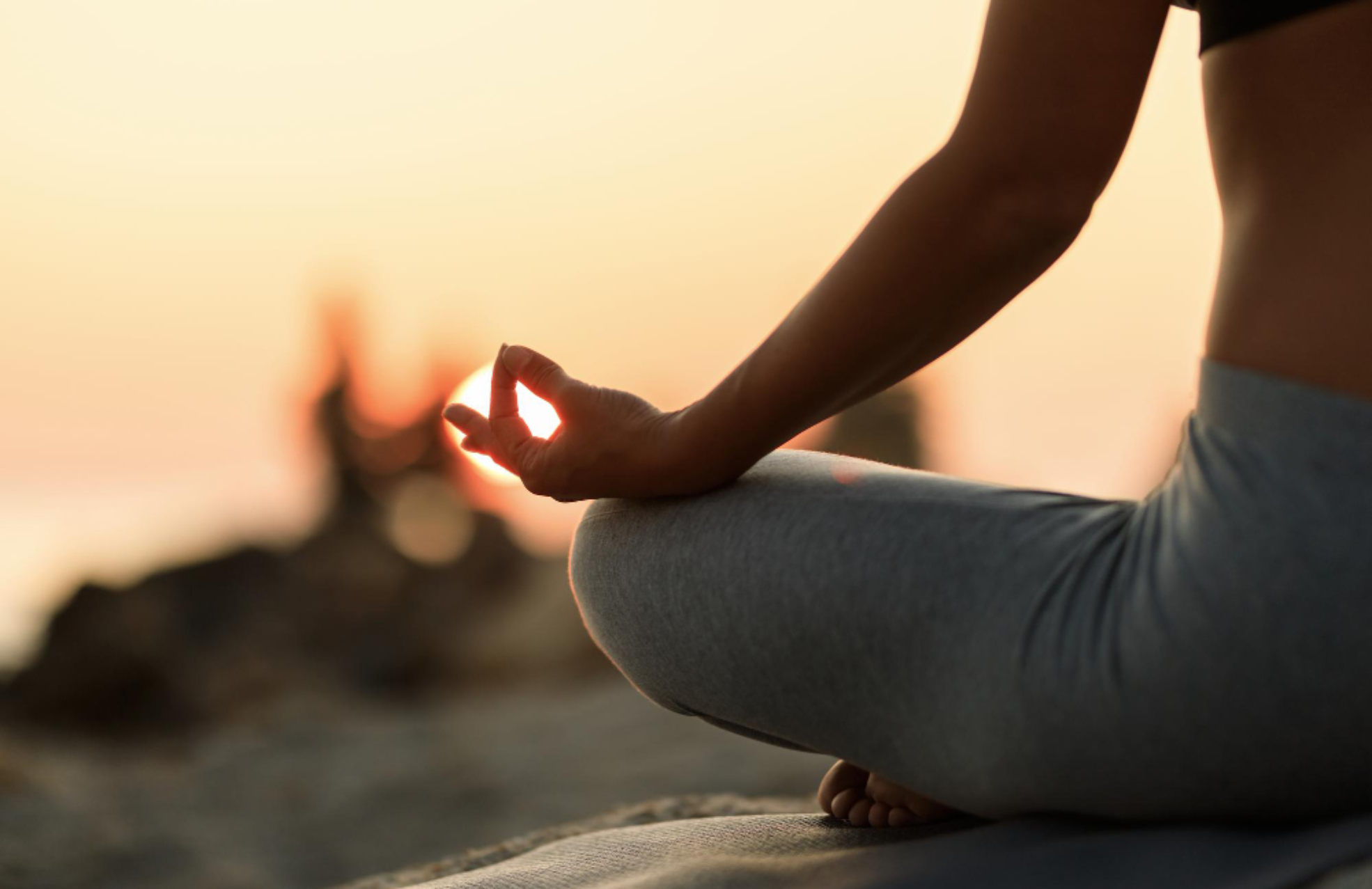 close-up-woman-meditating-lotus-position-sunset (1)