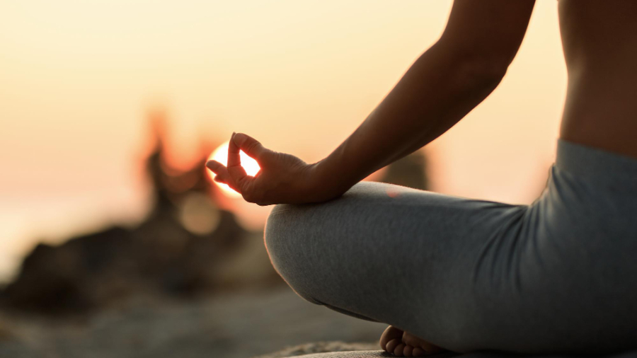 close-up-woman-meditating-lotus-position-sunset (1)