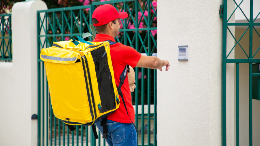 courier-uniform-with-isothermal-food-backpack-package-ringing-doorbell-shipping-delivery-service-concept